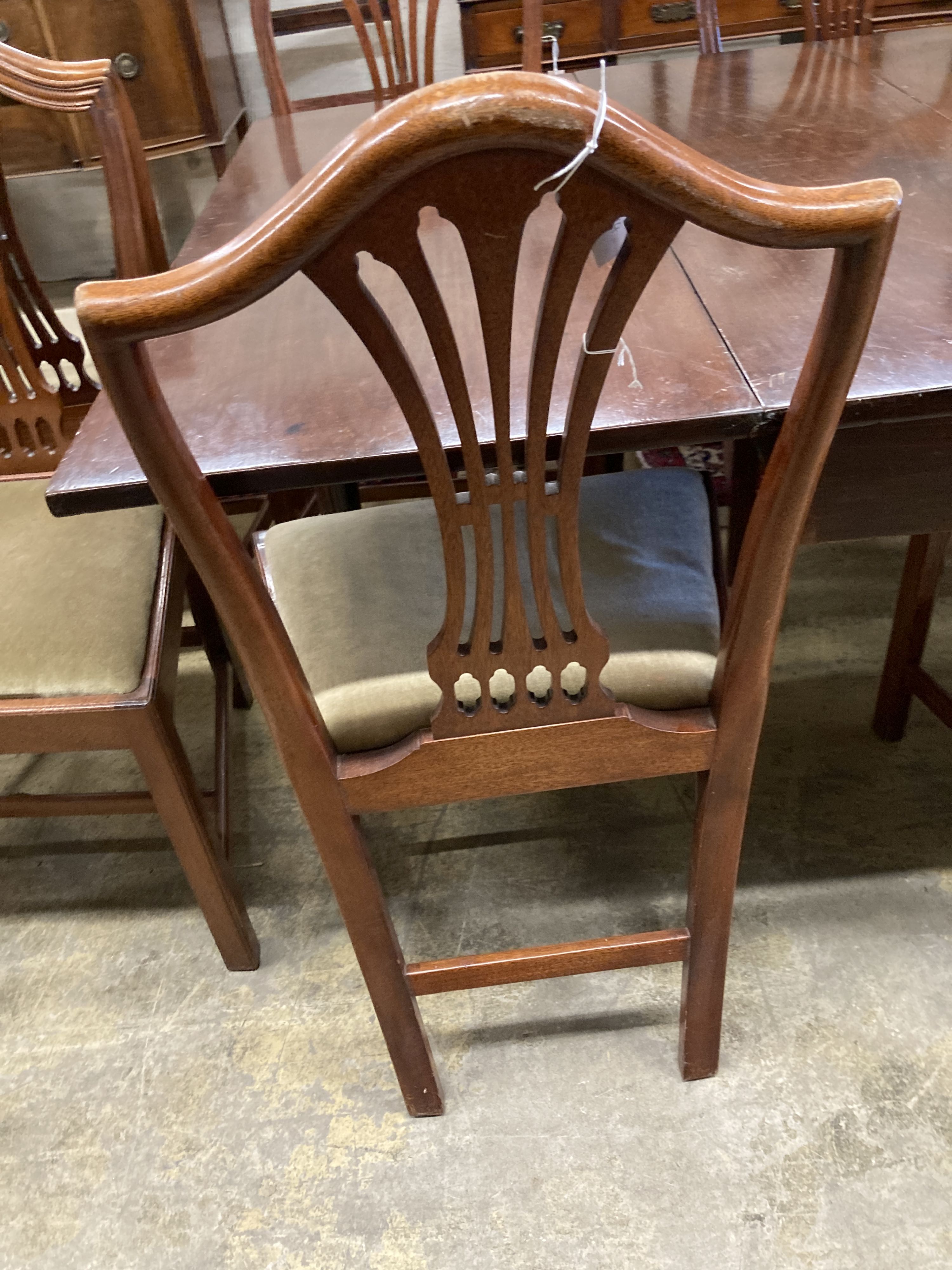 A set of eight Hepplewhite style mahogany pierced slat back dining chairs